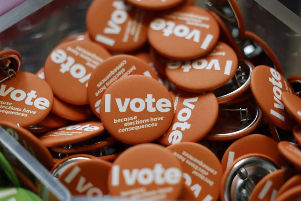 Harris slams 'offensive' Trump as rivals go west. Buttons being handed out during early voting for the general election at the University of Michigan Museum of Art Gallery in Ann Arbor, Michigan on October 31, 2024. | Photo by JEFF KOWALSKY / AFP