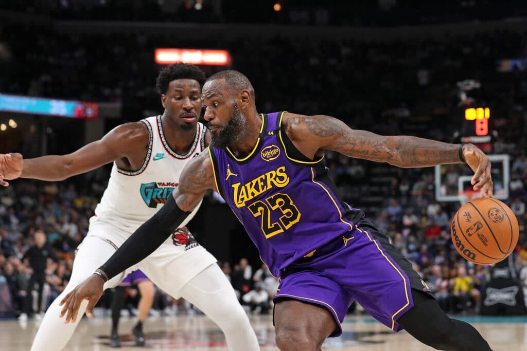  LeBron James #23 of Los Angeles team drives against Jaren Jackson Jr. #13 of the Memphis team.