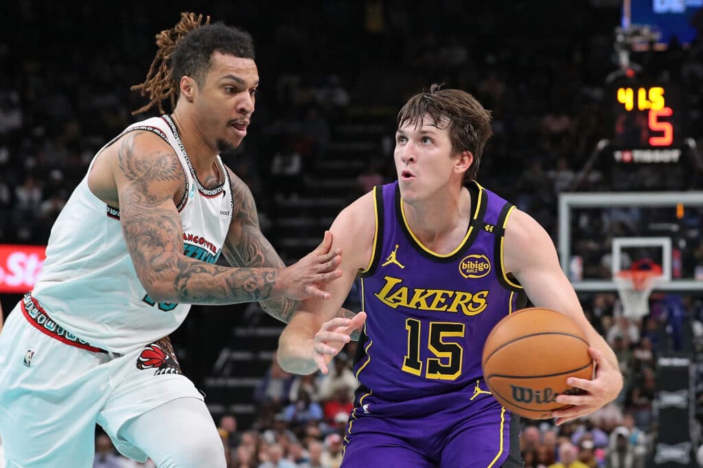 Austin Reaves #15 of the Los Angeles Lakers handles the ball against Brandon Clarke #15 of the Memphis Grizzlies during the first half at FedExForum on November 06, 2024 in Memphis, Tennessee. | Justin Ford/Getty Images/AFP