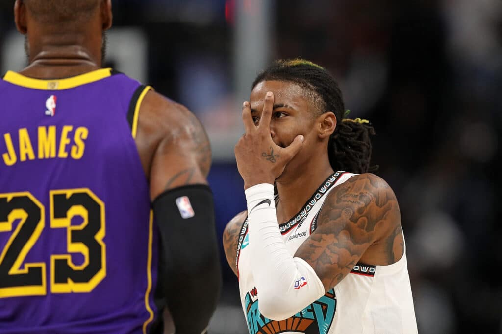 Ja Morant #12 of the Memphis Grizzlies reacts against LeBron James #23 of the Los Angeles Lakers during the first half at FedExForum on November 06, 2024 in Memphis, Tennessee. | Justin Ford/Getty Images/AFP