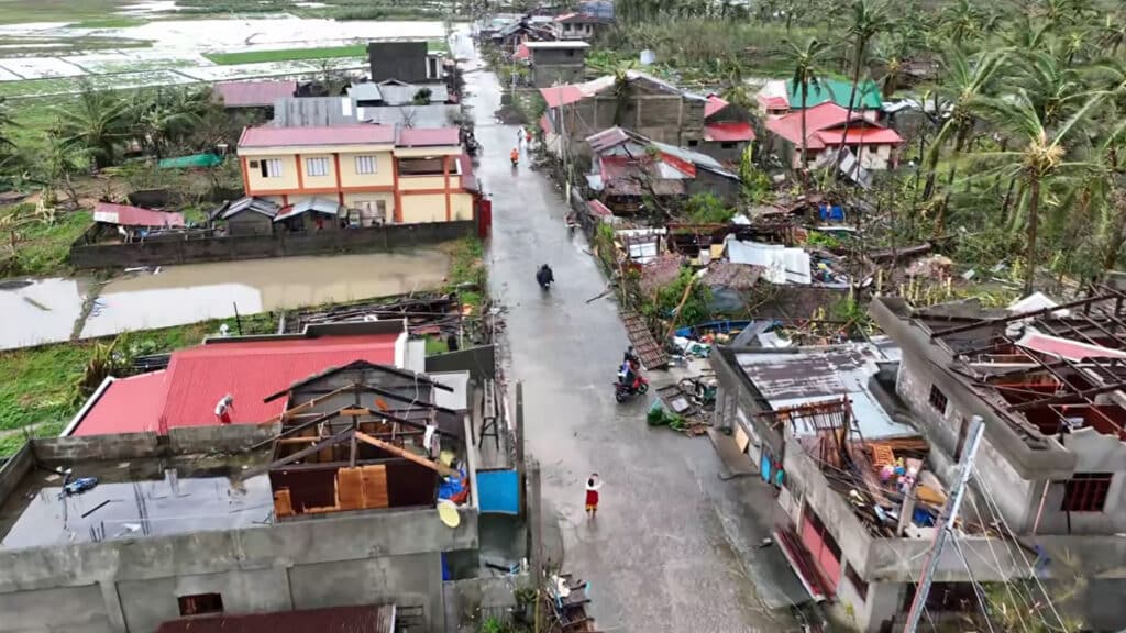 This frame grab from handout video footage taken and released on November 17, 2024 courtesy of Mayor Cesar Robles shows an aerial view of damaged houses in Panganiban town, Catanduanes province, after Super Typhoon Pepito hit the province. | Photo by Handout / Mayor Cesar Robles / AFP