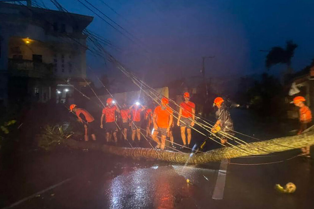 This handout photo taken on November 17, 2024 and released on November 18 by the Philippine Coast Guard (PCG) shows coast guard personnel clearing a road of debris in Baler, Aurora province, after Super Typhoon Pepito hit the province. |Photo by Philippine Coast Guard (PCG) /AFP