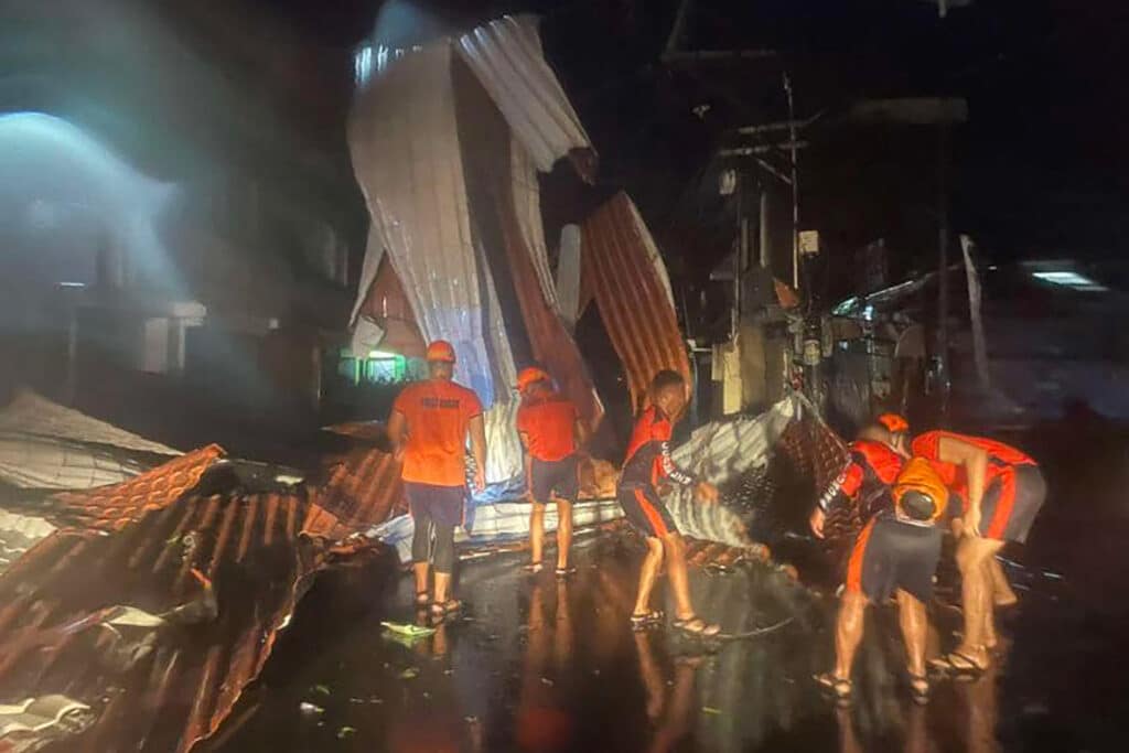 This handout photo taken on November 17, 2024 and released on November 18 by the Philippine Coast Guard (PCG) shows coast guard personnel clearing a road of debris in Baler, Aurora province, after Super Typhoon Man-yi hit the province. |Photo by Philippine Coast Guard (PCG) / AFP