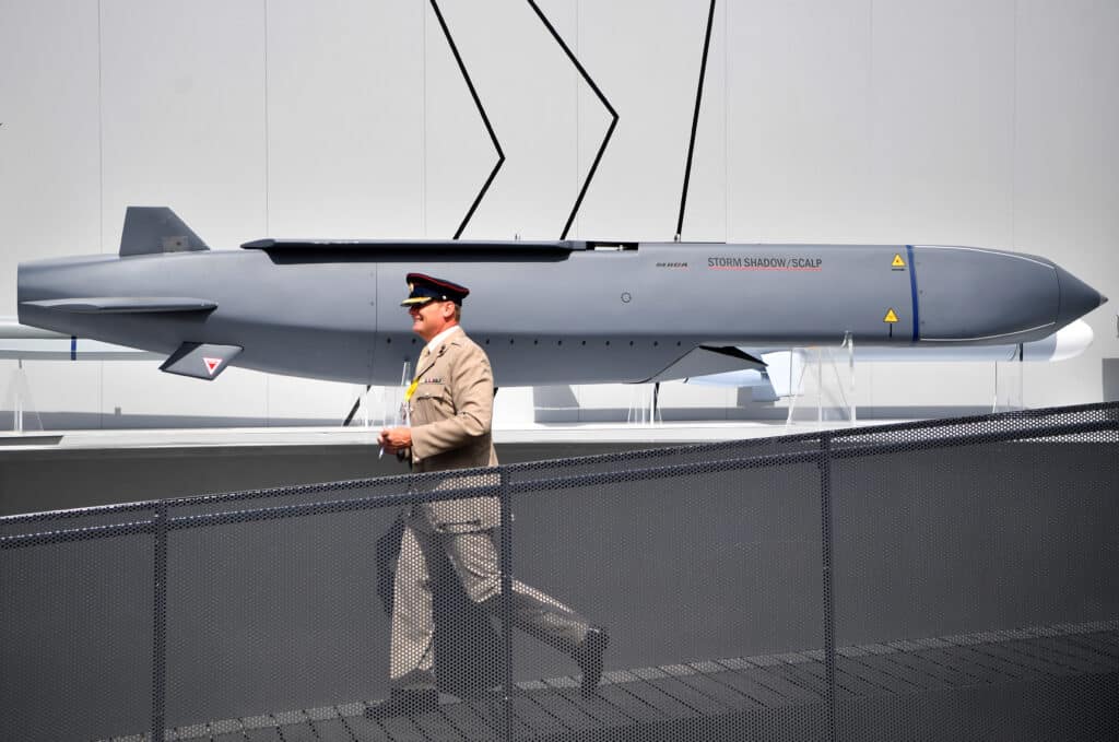 A member of the military walks past a MBDA Storm Shadow/Scalp missile at the Farnborough Airshow, south west of London, on July 17, 2018. | Photo by BEN STANSALL / AFP [FILE PHOTO]