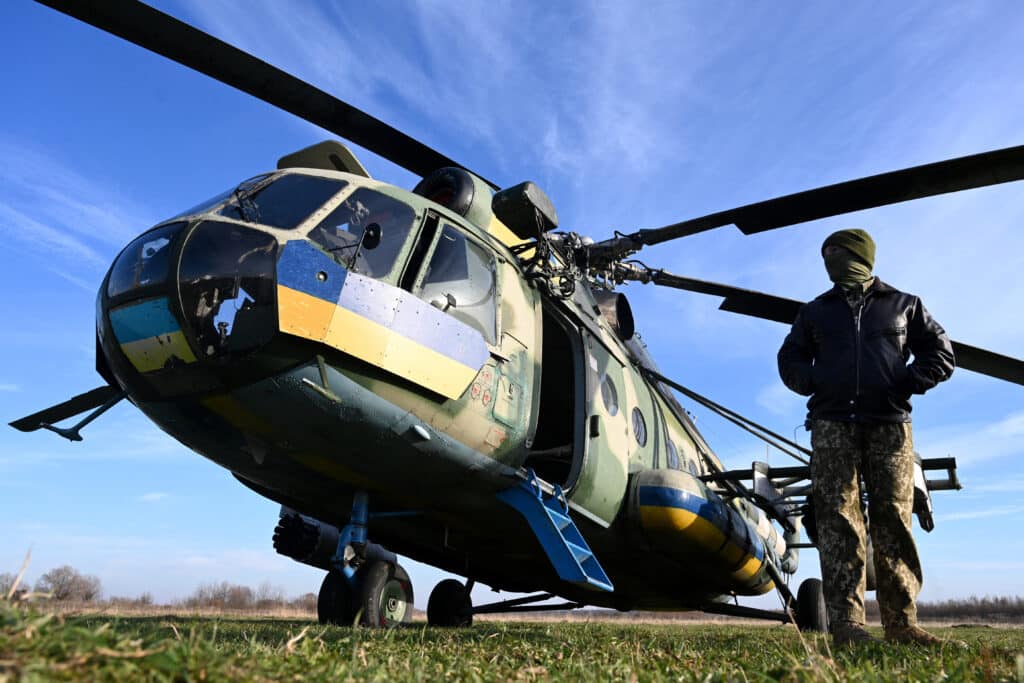 US to Ukraine: Draft 18-year-olds to fight Russia. Navigator Maxym stands next to a Mi-8 military helicopter during a training at an undisclosed location in Lviv region on November 7, 2024, amid the Russian invasion of Ukraine. | Photo by YURIY DYACHYSHYN / AFP