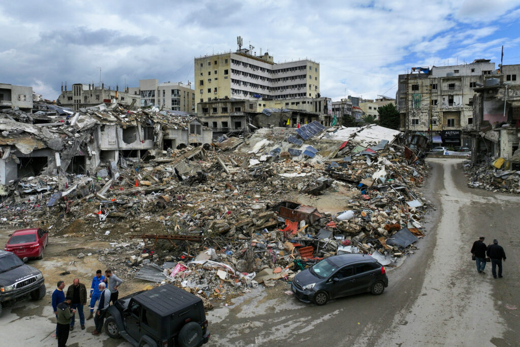 This areal view taken a day after a ceasefire between Israel and Hezbollah took hold shows people inspecting the damage in the southern Lebanese city of Nabatieh on November 28, 2024. Since the ceasefire took effect on November 27, tens of thousands of Lebanese who fled their homes headed back to their towns and villages, only to find scenes of devastation. (Photo by AFP)