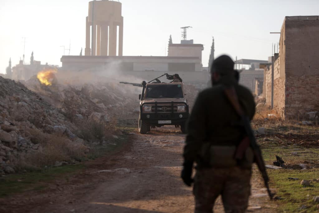 Fighters fire towards Syrian Army troops in the Rashidin district on the outskirts of Aleppo on November 29, 2024, as Hayat Tahrir al-Sham (HTS) jihadists and allied factions continue their offensive in the Aleppo province against government forces. |Photo by Bakr ALKASEM / AFP