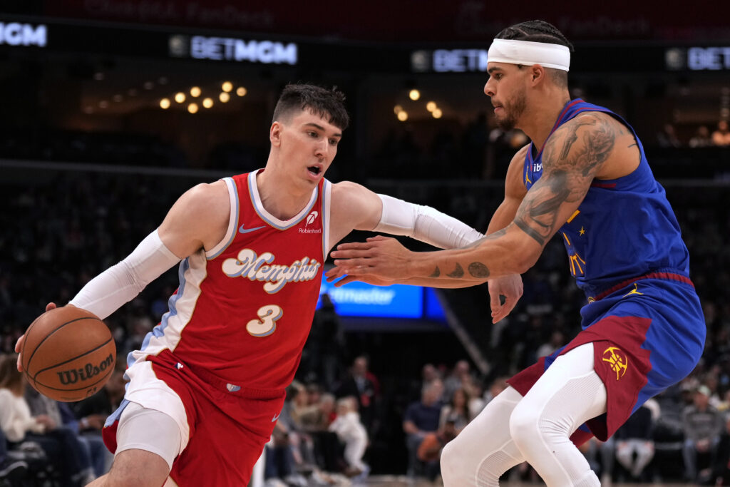 Memphis Grizzlies forward Jake LaRavia (3) drives against Denver Nuggets' Michael Porter Jr., right, in the first half of an NBA basketball game Sunday, Nov. 17, 2024, in Memphis, Tenn. (AP Photo/Mark Humphrey)