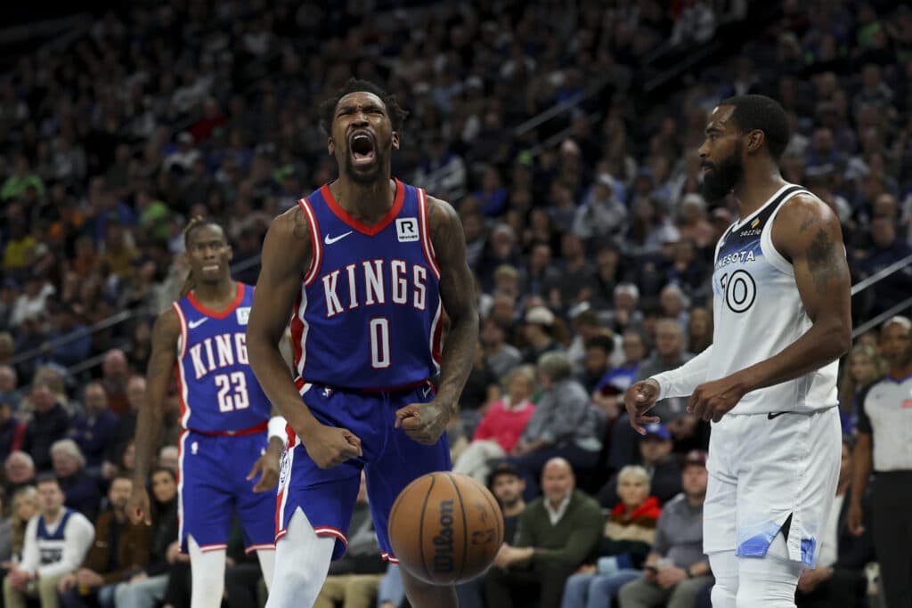 Sacramento Kings guard Malik Monk (0) reacts after scoring and drawing a foul while Minnesota Timberwolves guard Mike Conley (10) looks up the court during the first half of an NBA basketball game, Wednesday, Nov. 27, 2024, in Minneapolis. | AP Photo/Ellen Schmidt