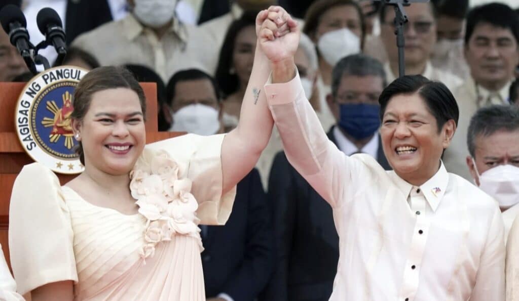 FILE - Philippine President Ferdinand Marcos Jr., center right, and Vice President Sara Duterte daughter of former Philippine President Rodrigo Duterte, raise hands during the inauguration ceremony at National Museum on Thursday, June 30, 2022 in Manila, Philippines.