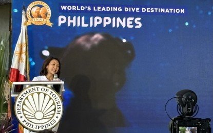 WORLD'S BEST. Tourism Secretary Christina Frasco announces the Philippines' win as the World's Leading Dive Destination in the 2024 WTA during the launch of the Philippine Dive Experience in Anilao, Mabini, Batangas on Thursday (Nov. 28, 2024). This is the sixth time the Philippines won its WTA title as leading dive destination. (PNA photo by Joyce Rocamora)