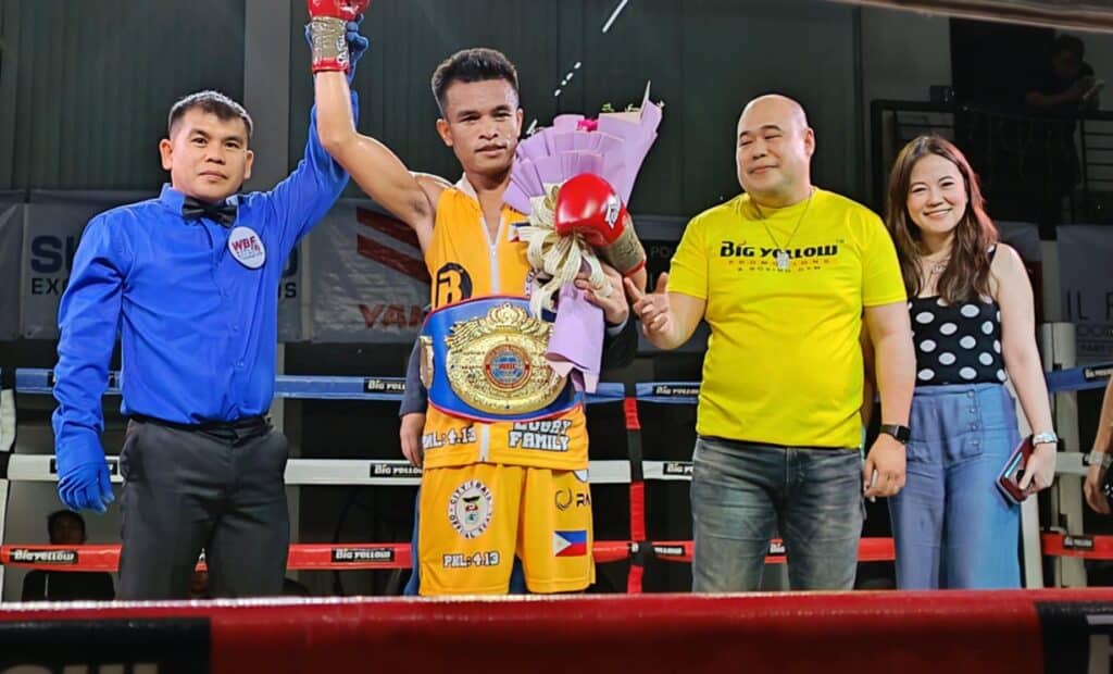 Referee Rey Caitom Jr. raises the hand of Rhonvex Capuloy with Big Yellow Boxing Promotions founder Seth Tio and promoter Mayang Tio. | Glendale Rosal