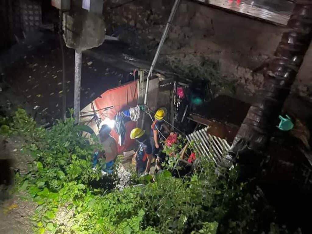 Emergency responders work to rescue two people trapped after a riprap collapsed on a house. | Contributed photo via Paul Lauro