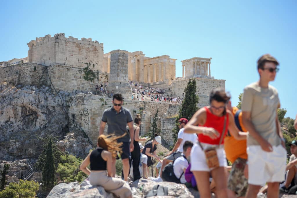 Climate change spurs disaster in 2024: 'Dangerous new era'. Tourists leave the Acropolis hill in Athens, on July 17, 2024. - The Greek Ministry of Culture announced a precautionary measure to ensure the safety of visitors during the heatwave, restricting access to the Acropolis site between 12pm and 5pm. (Photo by Aris Oikonomou / AFP)