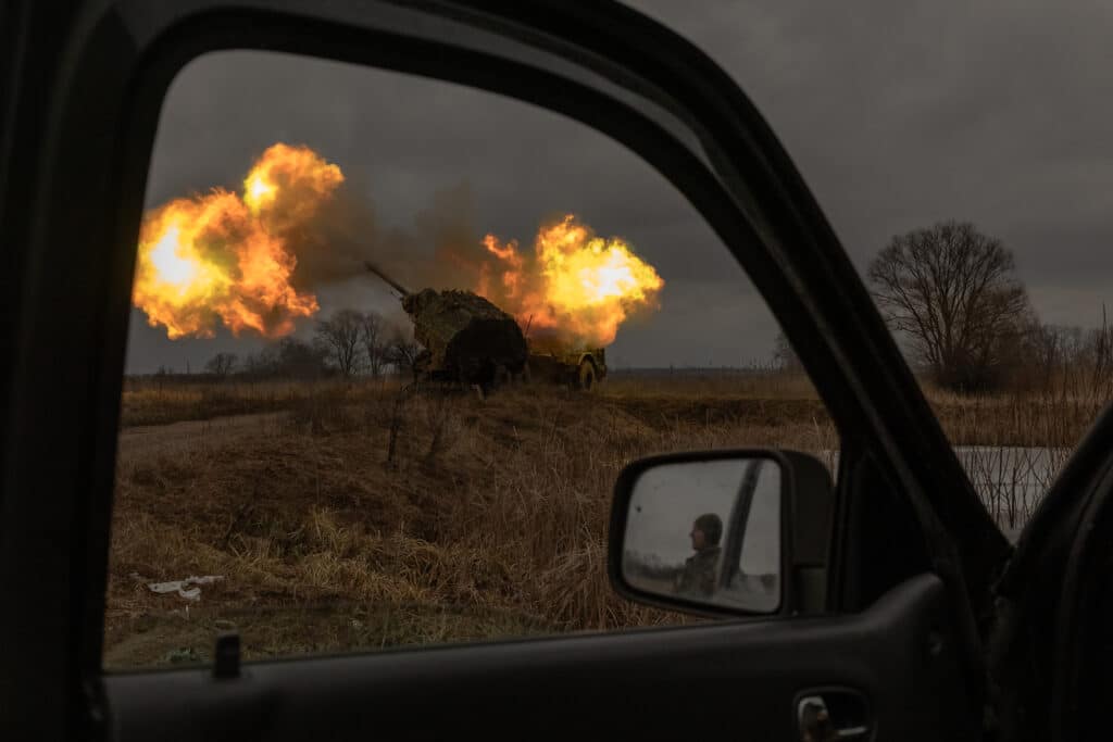 Ukraine: Trump's vows of quick peace fall flat on frontlines. In photo is a Ukrainian soldier being reflected in a car mirror looks on as a Swedish-made Archer Howitzer operated by Ukrainian members of the 45th Artillery Brigade fires towards Russian positions, in the Donetsk region, on January 20, 2024, amid the Russian invasion of Ukraine.  | Photo by Roman PILIPEY / AFP