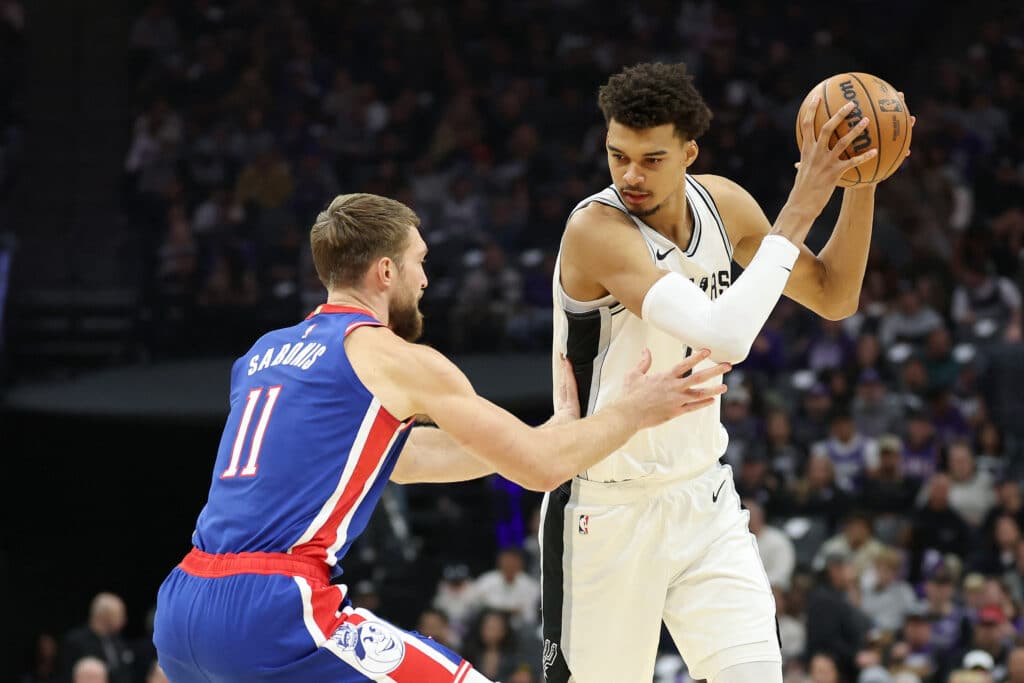 Victor Wembanyama #1 of the San Antonio Spurs is guarded by Domantas Sabonis #11 of the Sacramento Kings in the first half at Golden 1 Center on December 01, 2024 in Sacramento, California.| Ezra Shaw/Getty Images/AFP