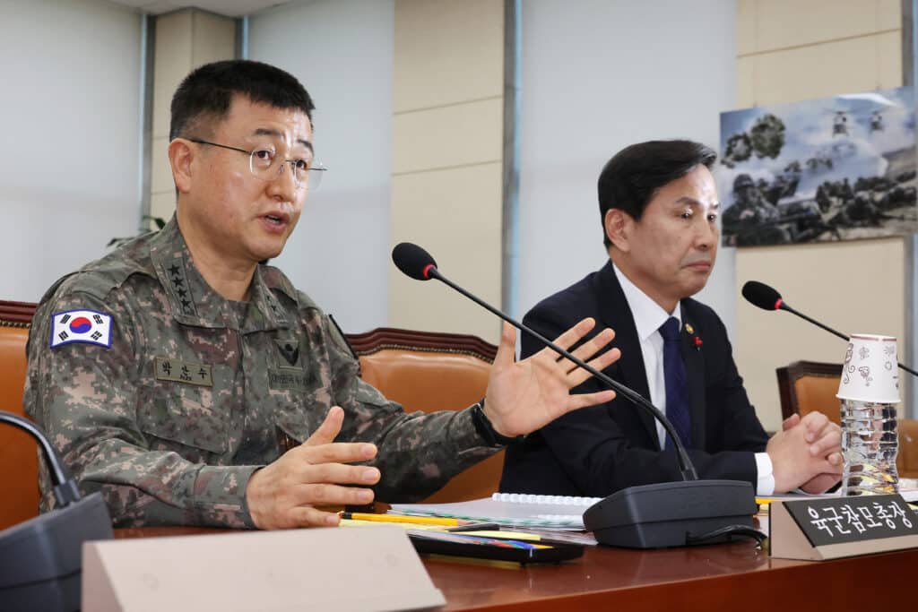 South Korea army chief General Park An-su (L) answers lawmakers' questions beside Vice Defence Minister Kim Seon-ho during a plenary session of the National Assembly Defence Committee, where an emergency question-and-answer session was held relating to President Yoon Suk Yeol's declaration and lifting of martial law, in Seoul on December 5, 2024. | Photo by YONHAP / AFP