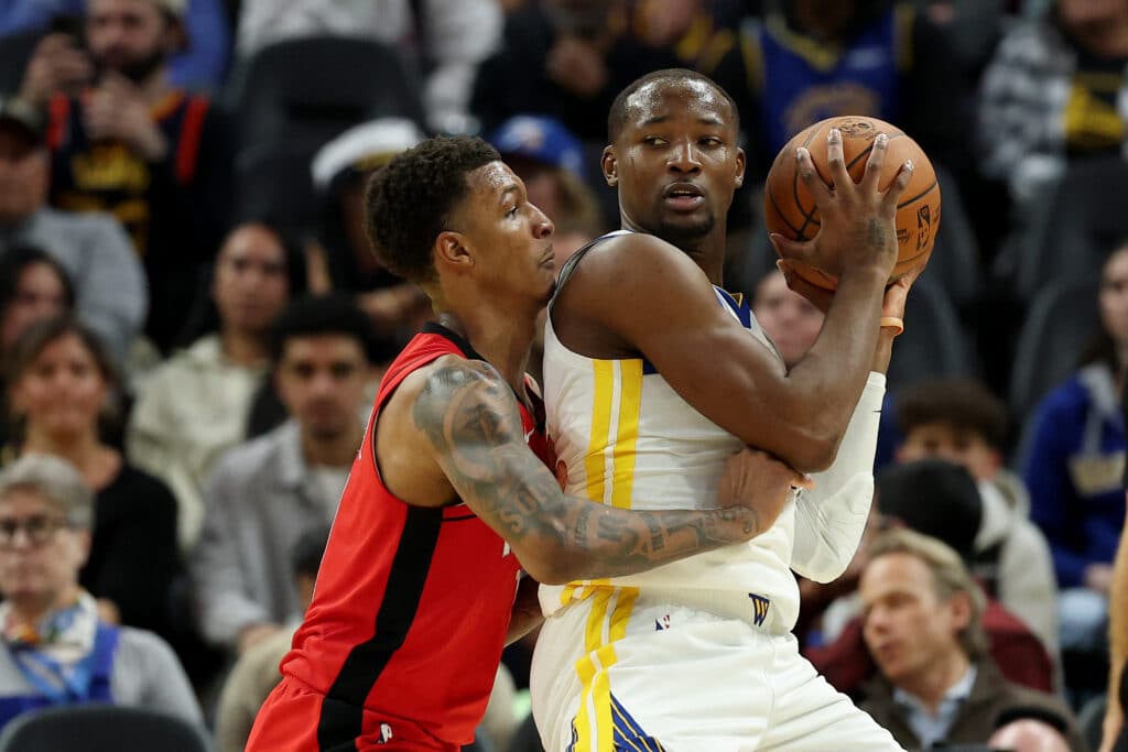 Jonathan Kuminga #00 of the Golden State Warriors is guarded by Jabari Smith Jr. #10 of the Houston Rockets in the second half at Chase Center on December 05, 2024 in San Francisco, California. Ezra Shaw/Getty Images/AFP