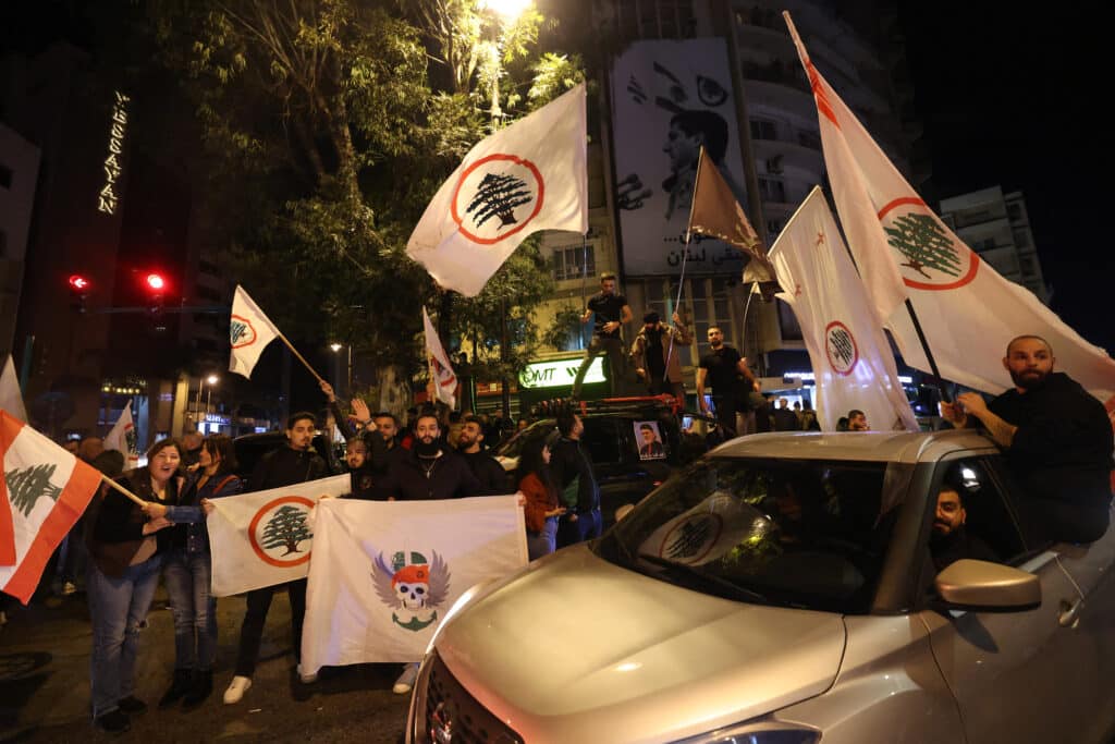 Supporters of the Christian Phalange party and the Lebanese Forces Party gather to celebrate in Beirut's neighbourhood of Achrafieh on December 8, 2024, after Islamist-led rebels declared that they have taken the Syrian capital. | Photo by IBRAHIM AMRO / AFP