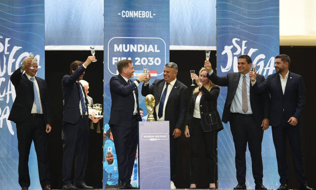 CONMEBOL President Paraguayan Alejandro Dominguez (3-L) toasts with the President of the Argentine Football Association (AFA), Claudio Tapia, as they celebrate the ratification of Argentina, Paraguay, and Uruguay as host countries of the FIFA 2030 World Cup during the FIFA virtual Congress in Luque, Paraguay, on December 11, 2024. | Photo by DANIEL DUARTE / AFP