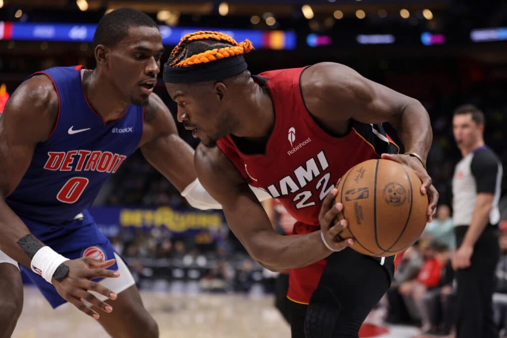 NBA: Pistons top Heat in overtime, Nuggets edge Kings. Jimmy Butler #22 of the Miami Heat looks to drive around Jalen Duren #0 of the Detroit Pistons during the second half at Little Caesars Arena on December 16, 2024 in Detroit, Michigan. Detroit won the game 125-124 in overtime. | Gregory Shamus/Getty Images/AFP