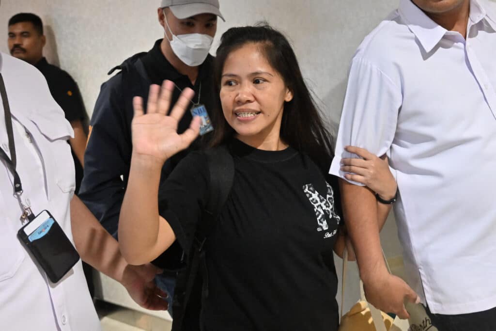 Filipina inmate on Indonesia death row, Mary Jane Veloso (center) waves as she is repatriated to Philippines after a press conference at the Soekarno-Hatta International Airport in Tangerang on December 17, 2024. |Photo by JUNI KRISWANTO / AFP