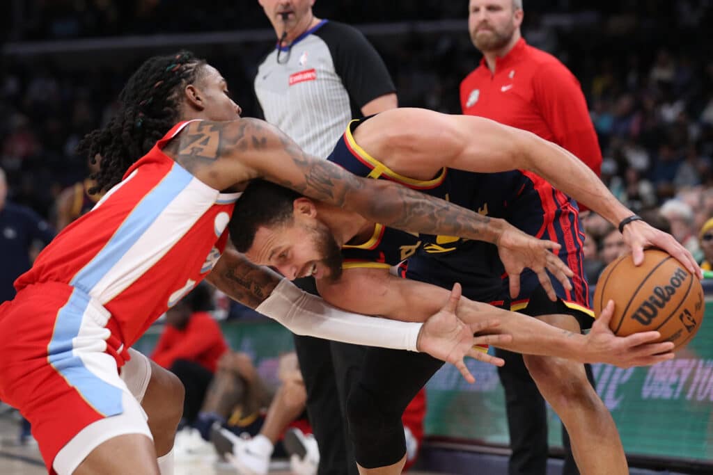 Stephen Curry #30 of the Golden State Warriors handles the ball against Ja Morant #12 of the Memphis Grizzlies during the first half at FedExForum on December 19, 2024 in Memphis, Tennessee. | Justin Ford/Getty Images/AFP