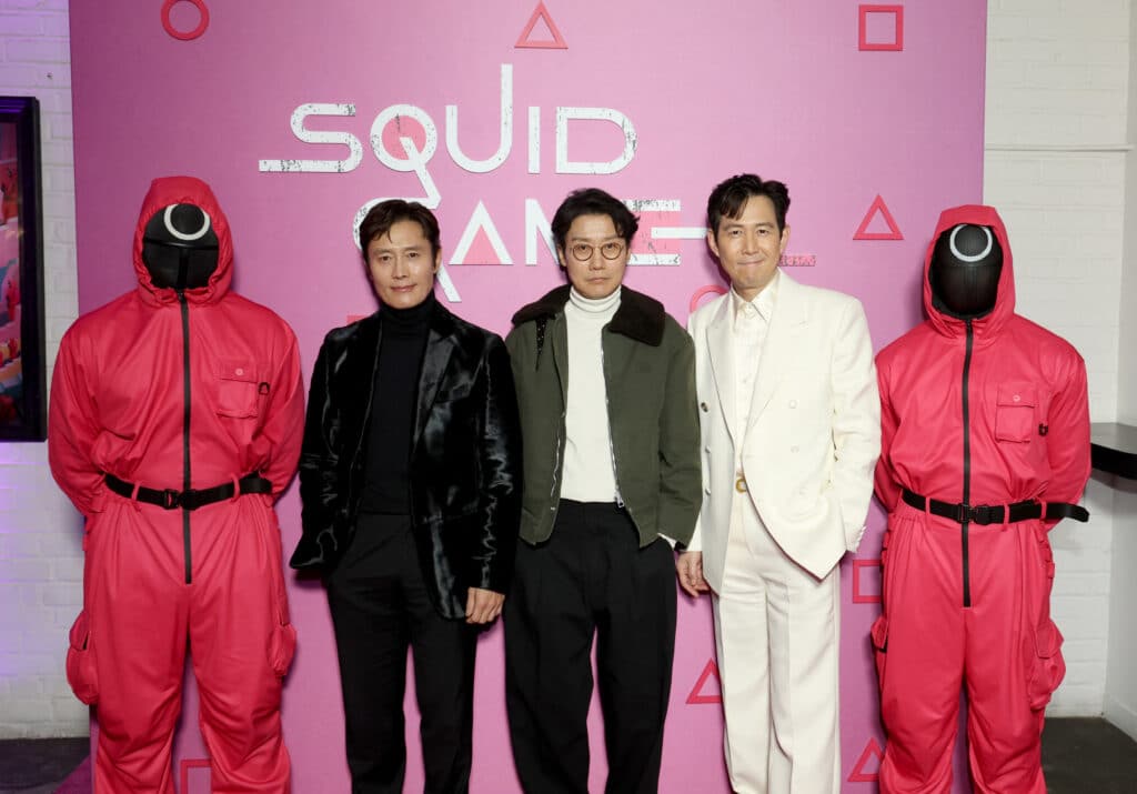 Lee Byung-hun, Hwang Dong-hyuk, and Lee Jung-jae pose with Pink Soldiers at the Netflix series Squid Game Season 2 SAG Screening at Metrograph on December 16, 2024 in New York City.   Mike Coppola/Getty Images for Netflix/AFP