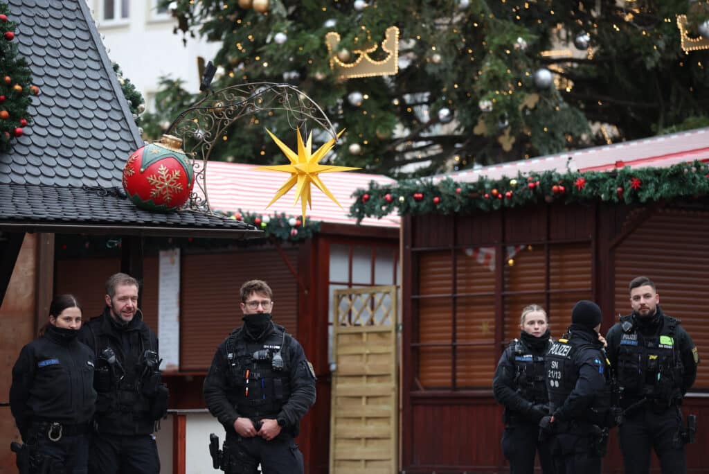 Christmas market attack: Sorrow and fury in German town. Police officers stand at the site of a Christmas market where a car crashed into a crowd injuring more than 60 people the evening before, on December 21, 2024 in Magdeburg, eastern Germany. - At least one person was killed and 68 injured December 20, 2024 in a suspected attack on a Christmas market in the eastern Germany city of Magdeburg, local authorities said. (Photo by Ronny HARTMANN / AFP)