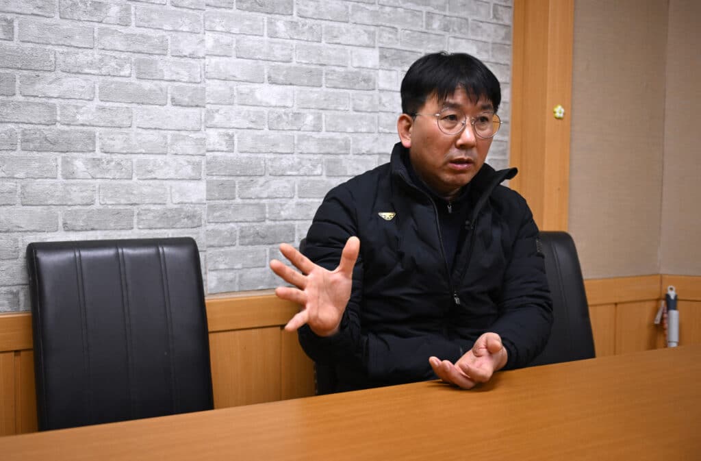 This picture taken on November 5, 2024 shows Lee Chang-kun, a worker at South Korea's KG Mobility -- formerly operated as Ssangyong Motor -- who took part in a 100-day sit-in strike perched on a company tower in 2009, speaking during an interview with AFP at a labour union office in Pyeongtaek. | Photo by Jung Yeon-je / AFP