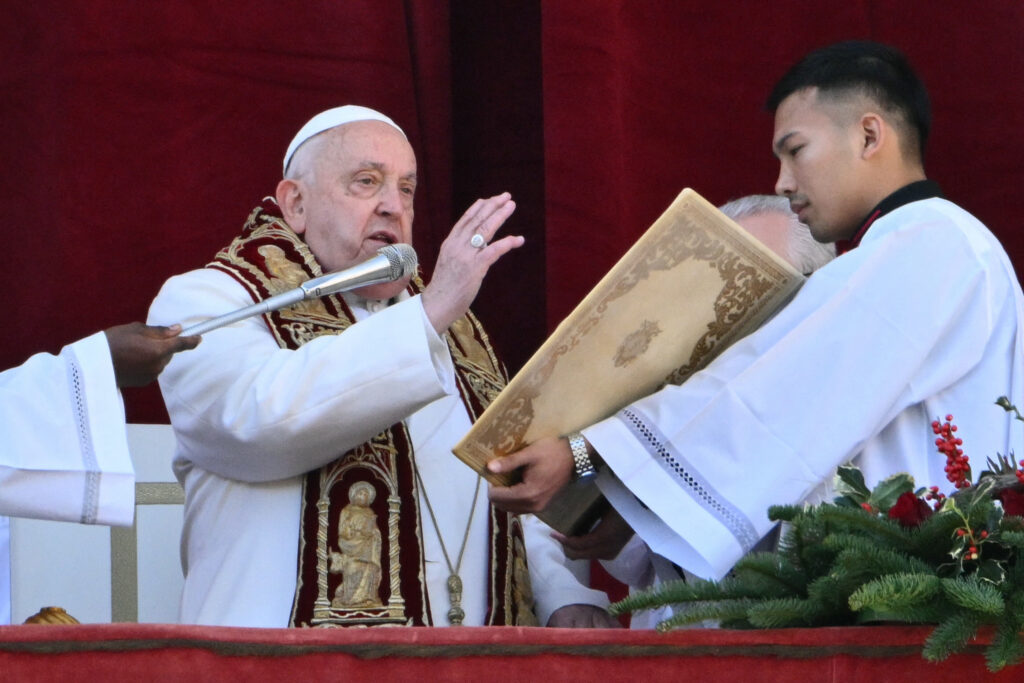 Pope Francis calls for 'arms to be silenced' in Christmas appeal. In photo is Pope Francis delivering the Urbi et Orbi message and blessing to the city and the world from the main balcony of St. Peter's basilica as part of Christmas celebrations, at St Peter's square in the Vatican on December 25, 2024. (Photo by Alberto PIZZOLI / AFP)