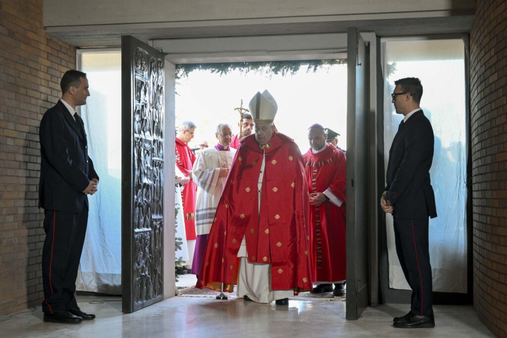 This photo taken and handout on December 26, 2024 by The Vatican Media shows Pope Francis opening a Holy Door at Rebibbia Penitentiary on Saint Stephen day in Rome as part of the Catholic Jubilee Year. | Photo by Handout / VATICAN MEDIA / AFP