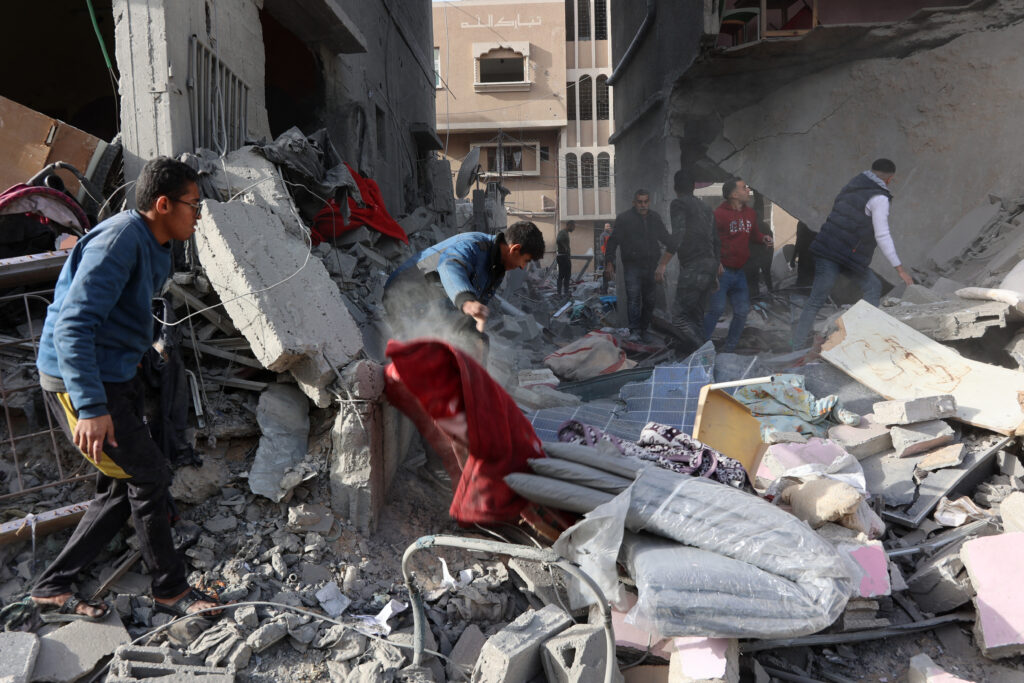 Civilians check the site of an Israeli strike in a residential area at Tuffah neighbourhood, east of Gaza City, on December 26, 2024, amid the ongoing war between Israel and the Palestinian Hamas movement.| Photo by Omar AL-QATTAA / AFP