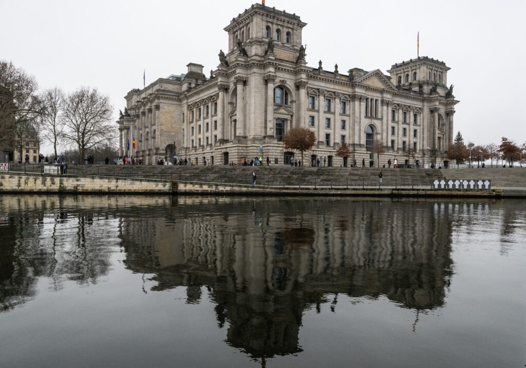 German president dissolves parliament, sets Feb 23 election date. The Reichstag building, which houses Germany's lower house of parliament (Bundestag) is reflected in the river Spree in Berlin on December 27, 2024. | Photo by John MACDOUGALL / AFP