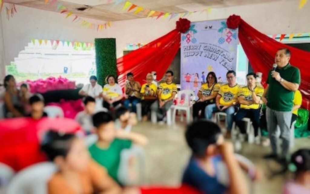 GIFT-GIVING. Bago City Mayor Nicholas Yulo (right) gives a message to families displaced by the eruption of Mt. Kanlaon during the Christmas celebration sponsored by the City Hall employees in one of the evacuation centers on Monday (Dec. 23, 2024). (Photo courtesy of Bago City Information Office)