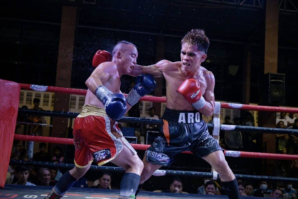 ARQ's Ian Abne climbs to No. 10 in IBF minimumweight rankings. Ian Paul Abne (in black trunks) lands a punch during his December bout against Chinese fighter Jin Ping Yang. | Photo courtesy of ARQ Sports