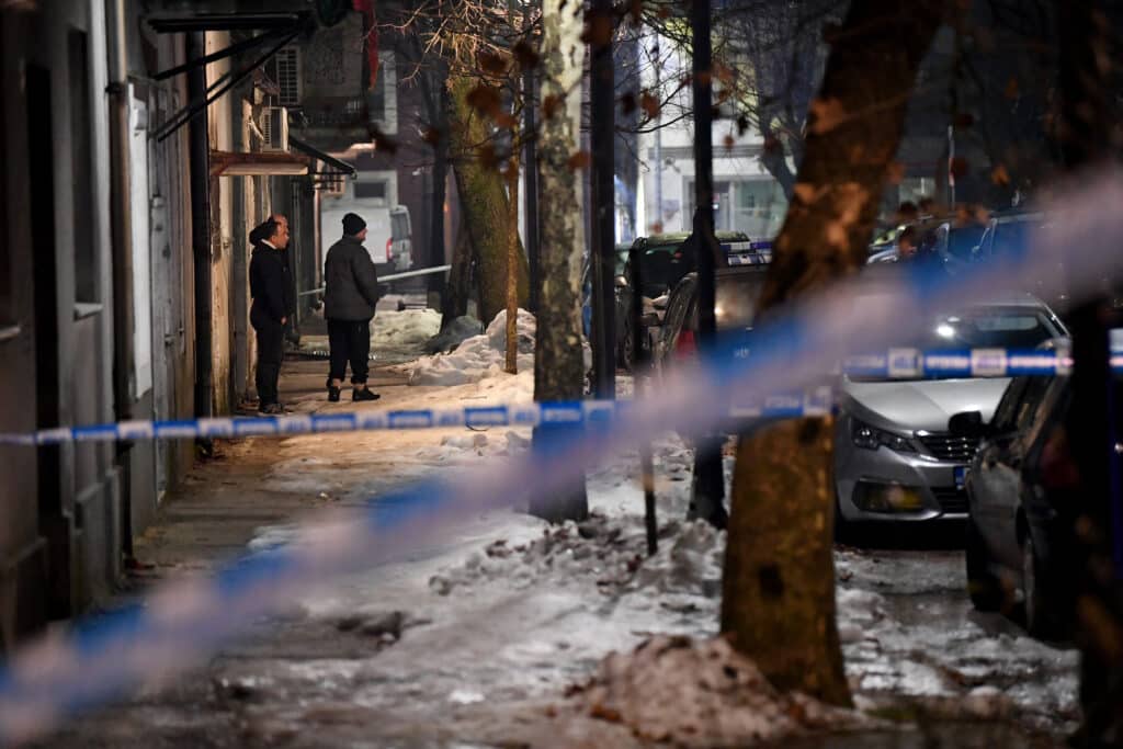 Police officers and civil protection units secure a crime scene after a gunman killed several people in the village of Bajice near Cetinje, on January 1, 2025. | Photo by SAVO PRELEVIC / AFP