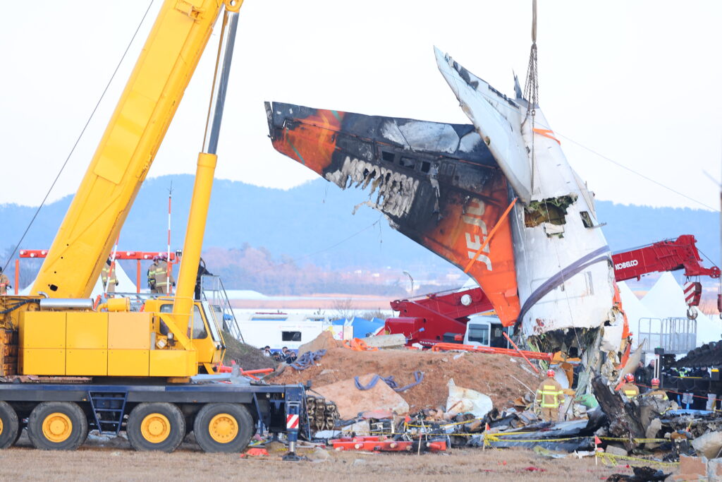 South Korea begins lifting Jeju Air wreckage after fatal crash. A crane lifts the tail section during the salvage operation of the Jeju Air Boeing 737-800 aircraft which crashed and burst into flames at Muan International Airport, in Muan on January 3, 2025.| Photo by YONHAP / AFP