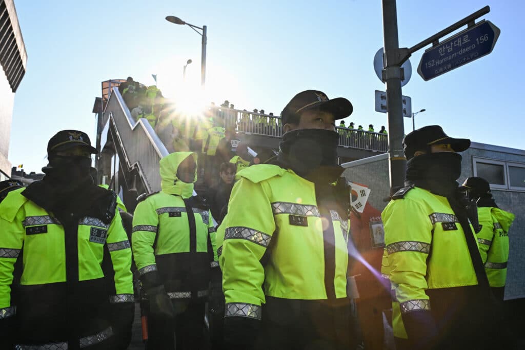 South Korea investigators in standoff to arrest President Yoon. Police keep watch as supporters of South Korea's impeached President Yoon Suk Yeol gather near his residence in Seoul on January 3, 2025. | Photo by Philip FONG / AFP