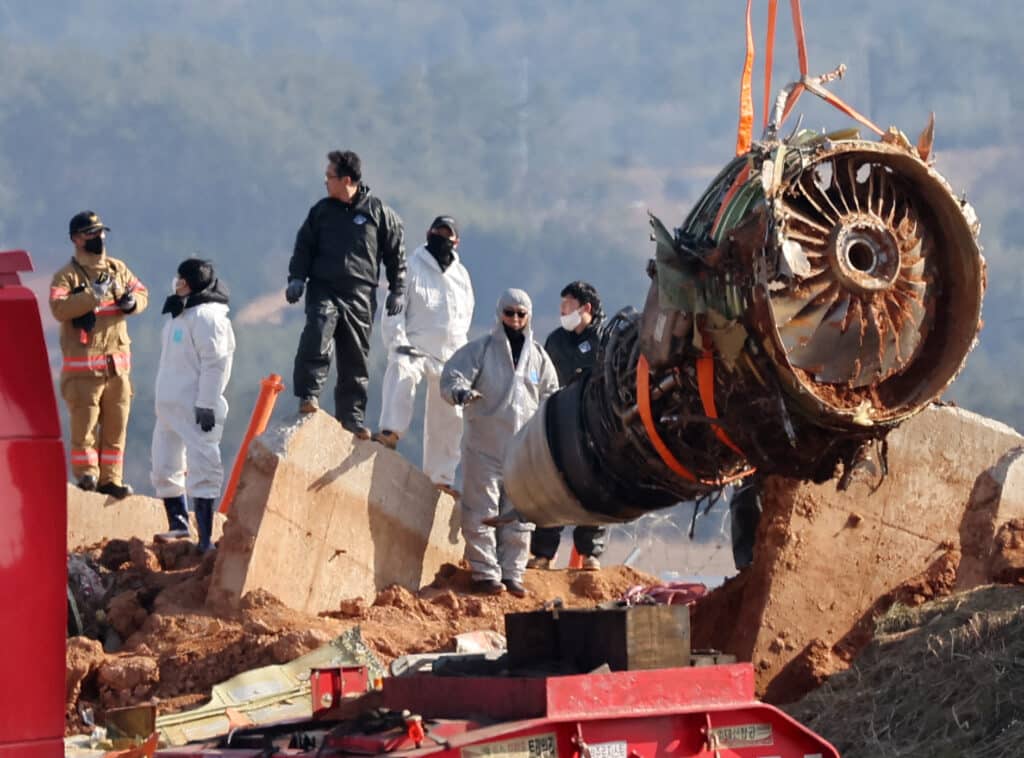 Teams salvage an engine of the Jeju Air Boeing 737-800 aircraft which crashed and burst into flames at Muan International Airport, in Muan on January 3, 2025. | Photo by YONHAP / AFP