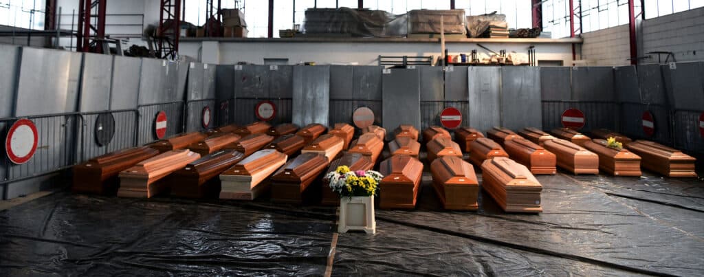 (FILES) A view shows some of 35 coffins of deceased people stored in a warehouse in Ponte San Pietro, near Bergamo, Lombardy, on March 26, 2020, prior to be transported to another region for cremation during the country's lockdown following the COVID-19 new coronavirus pandemic. | Photo by Piero CRUCIATTI / AFP [FILE PHOTO]