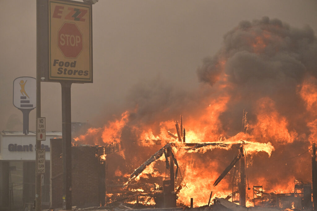 Celebrities flee Los Angeles fires as Hollywood events scrapped. In photo is a food store burning during the Eaton Fire in Altadena, California, on January 8, 2025.| Photo by Robyn Beck / AFP