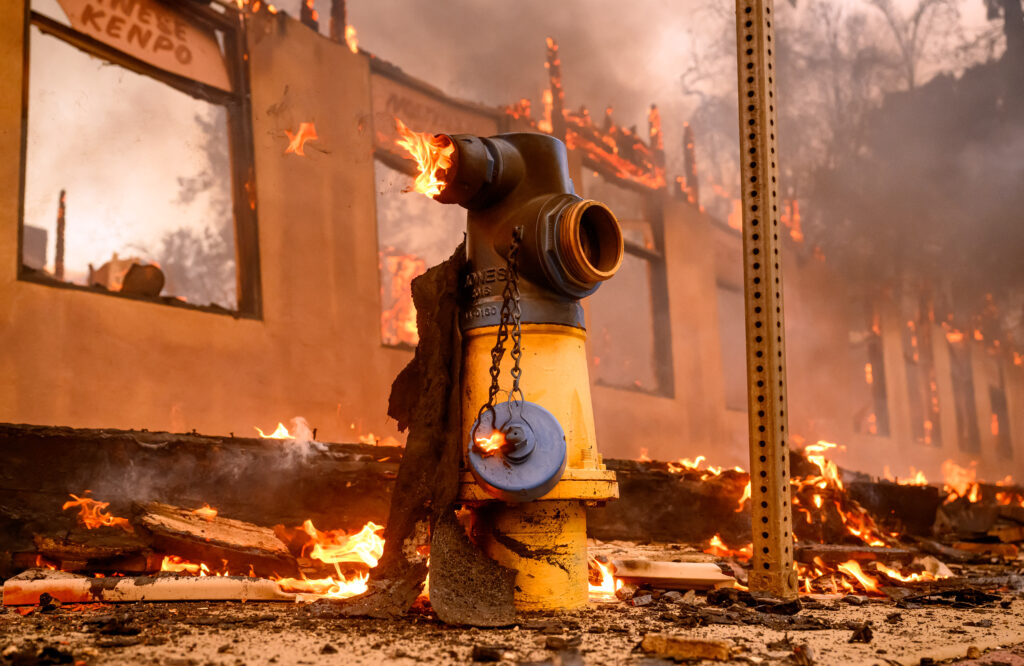 A fire hydrant burns during the Eaton fire in the Altadena area of Los Angeles county, California on January 8, 2025. | Photo by JOSH EDELSON / AFP