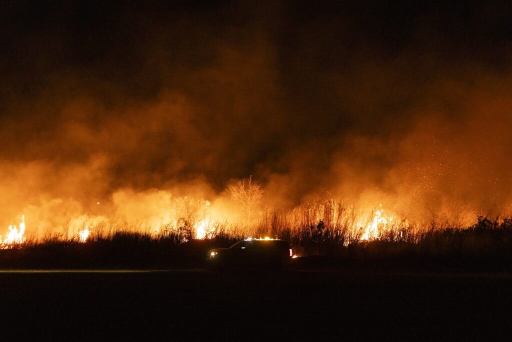 Fire tornadoes are a risk under California's extreme wildfire conditions. A fire truck drives along a riverbed set ablaze by the Auto Fire in Oxnard, North West of Los Angeles, California, on January 13, 2025. US officials warned "dangerous and strong" winds were set to push deadly wildfires further through Los Angeles residential areas January 12 as firefighters struggled to make progress against the flames.| Photo by ETIENNE LAURENT / AFP