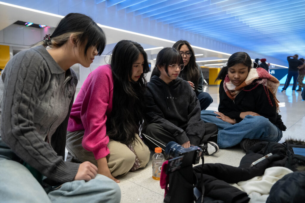 Members of Eternal Dance Crew review a practice recorded dance filmed for social media, including TikTok, inside Moynihan Train Hall on January 14, 2025 in New York City.| Adam Gray/Getty Images/AFP