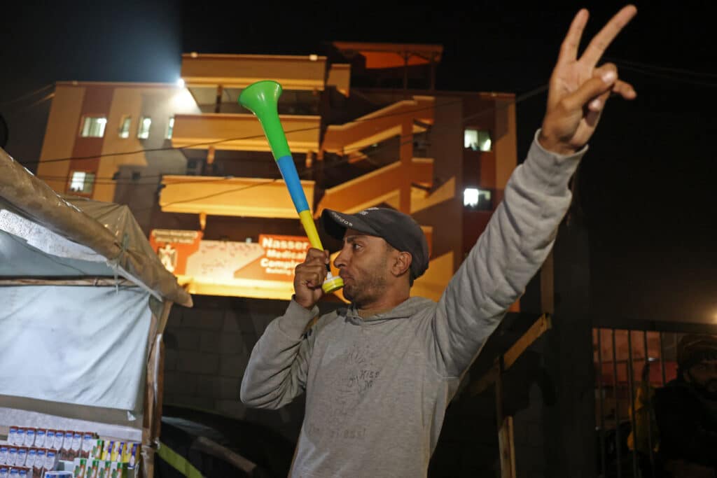 Ceasefire deal in Gaza: What are the details?. A man celebrates along a street in Khan Yunis in the southern Gaza Strip on January 15, 2025 after thousands of Gazans heard news that a ceasefire and hostage release deal has been reached by Israel and Hamas. | (Photo by BASHAR TALEB / AFP)