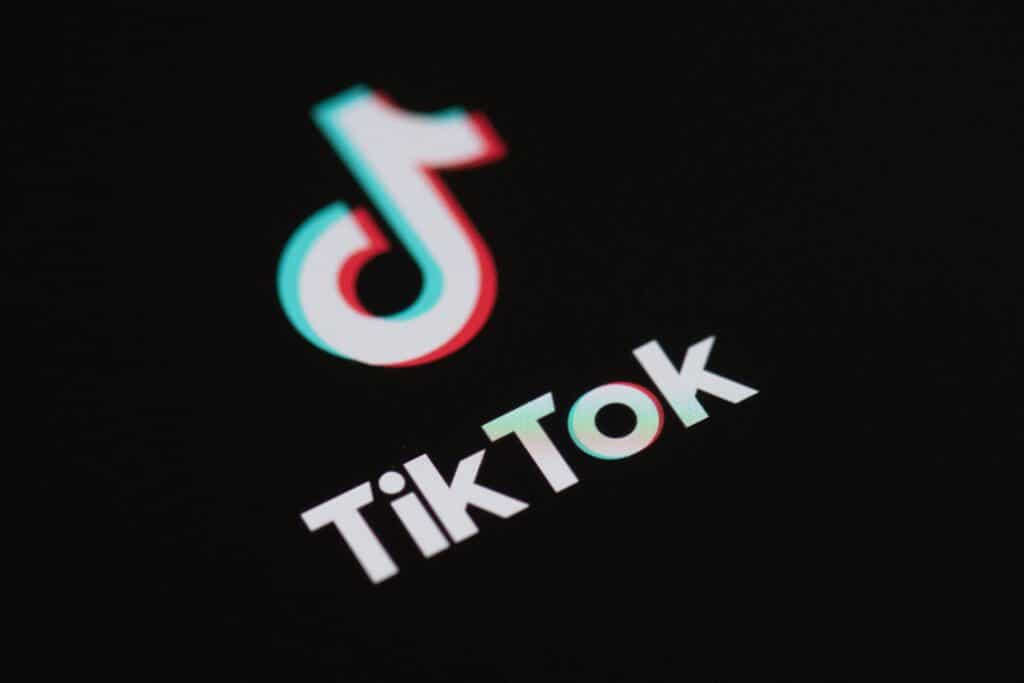 (FILES) This illustration picture taken on May 27, 2020 in Paris shows the logo of the social network  application Tik Tok on the screen of a phone. TikTok will "go dark" in the United States on Sunday unless the government gives clear assurances that service providers won't be held liable for breaking a law banning the video-sharing platform, it said January 17. (Photo by Martin BUREAU / AFP)