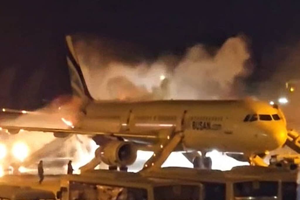 Firefighters work to extinguish a fire that broke out on an Air Busan passenger plane at Gimhae International Airport in Busan on January 28, 2025. | Photo by YONHAP / AFP