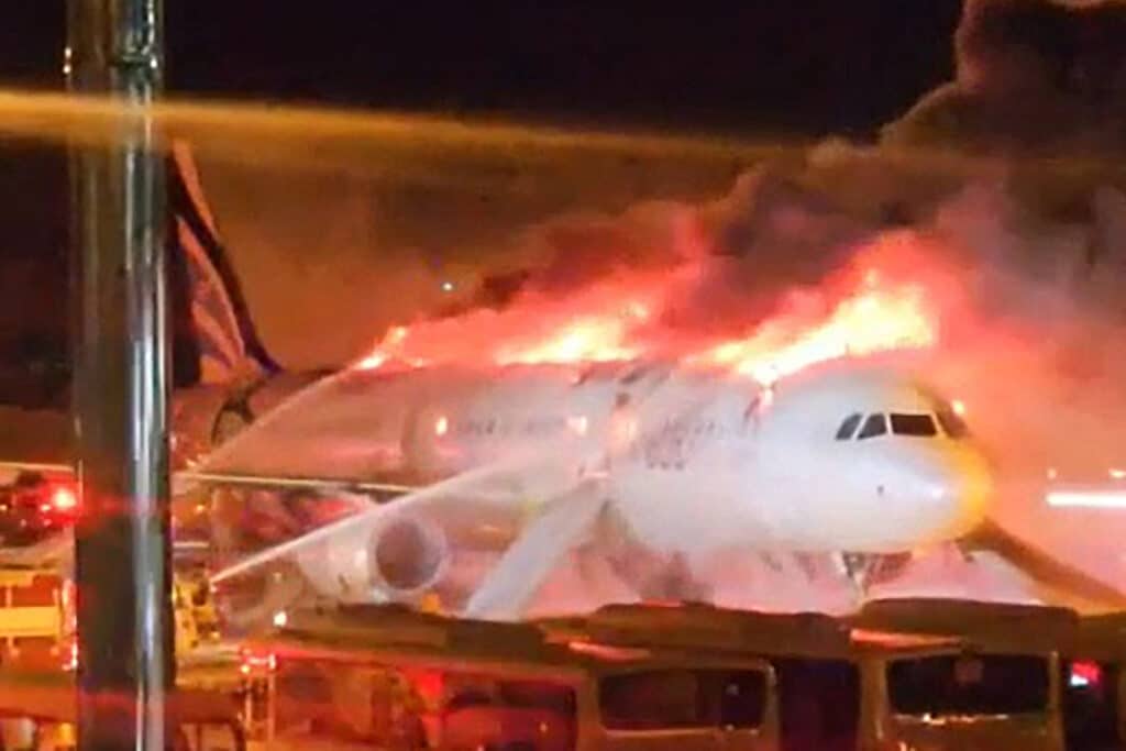 Fire authorities work to extinguish a fire that broke out on an Air Busan passenger plane at Gimhae International Airport in Busan on January 28, 2025. The tail of a passenger aircraft caught fire at an international airport in South Korea's second-largest city on January 28, forcing the evacuation of 176 people on board, Yonhap news agency reported. (Photo by YONHAP / AFP)