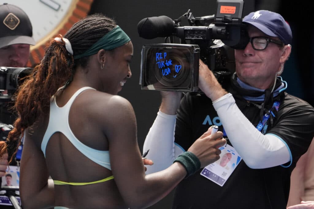 Coco Gauff writes 'RIP TikTok USA' on a TV camera at the Australian Open. Coco Gauff of the U.S. writes "RIP Tik Tok USA" after defeating Belinda Bencic of Switzerland in a fourth round match at the Australian Open tennis championship in Melbourne, Australia, Sunday, Jan. 19, 2025. (AP Photo/Asanka Brendon Ratnayake)